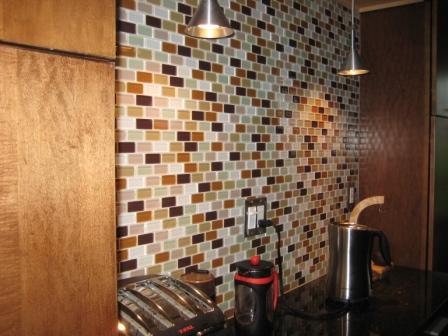 New glass tiles gleam in the kitchen